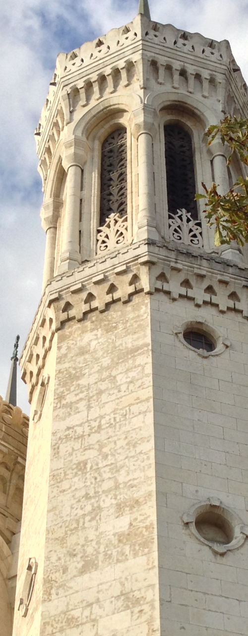 Historic white stone basilica under cloudy sky