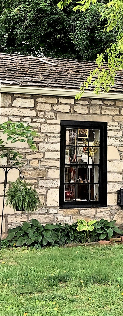 Historic stone building with Jim's Journey sign