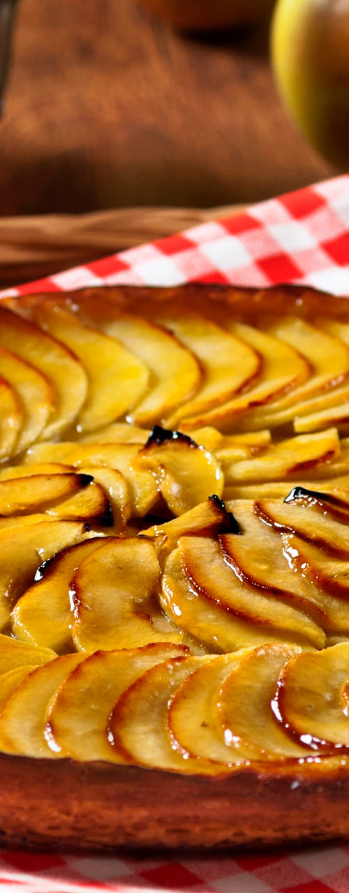 Golden apple tart on checkered cloth