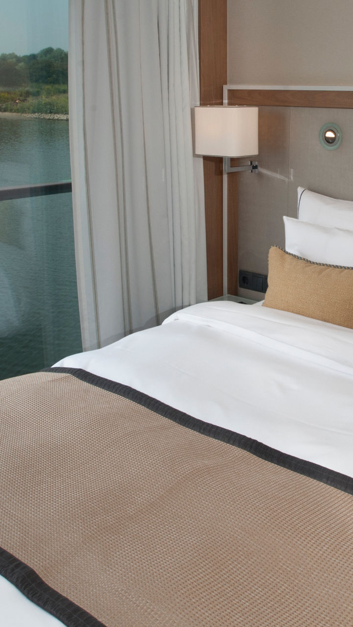 Modern river-view hotel room with cozy decor