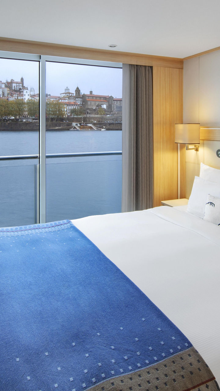 Modern riverfront hotel room with balcony view