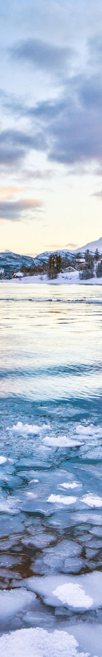 Snowy mountain lake at sunrise