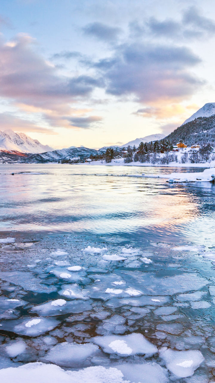 Snowy mountain lake at sunrise