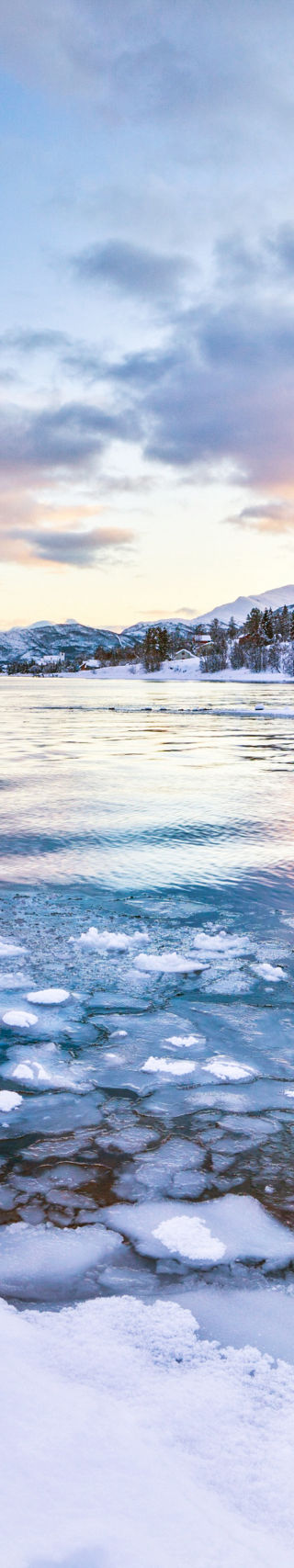 Snowy mountain lake at sunrise