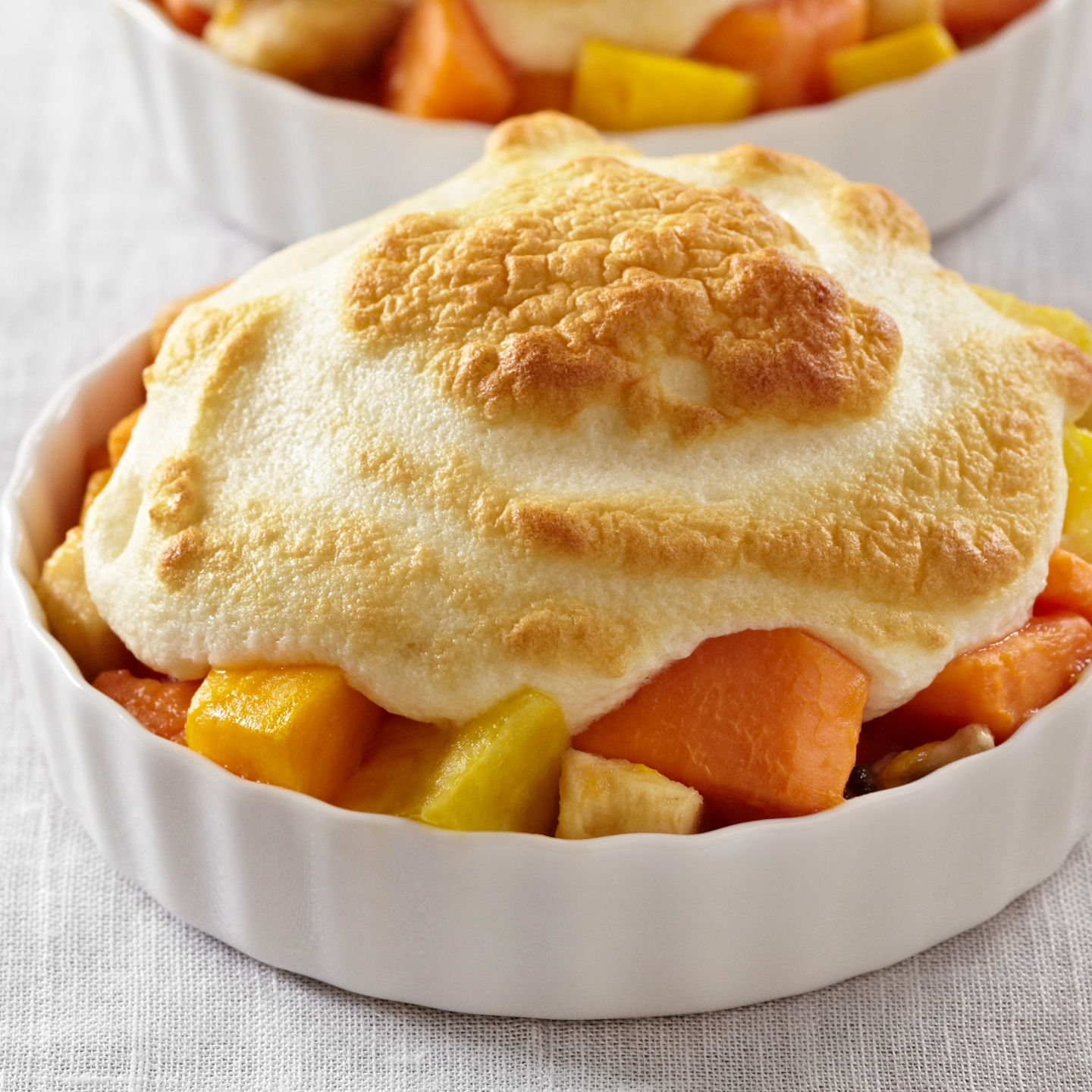 Baked fruit desserts in white ramekins