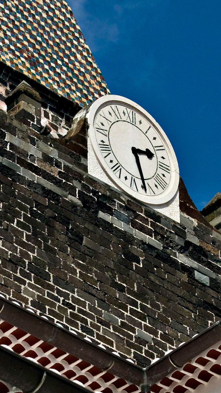 Historic clock tower against blue sky