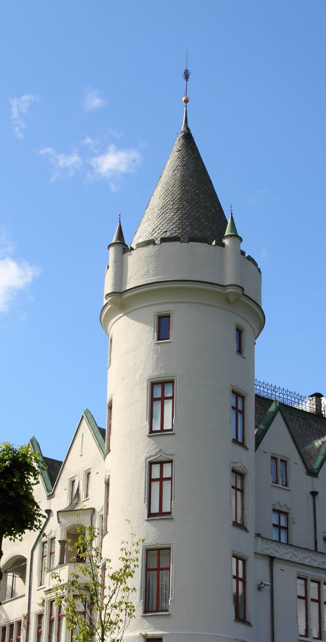 Elegant white castle on sunny hillside