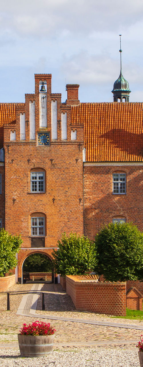 Historic red brick castle with gardens