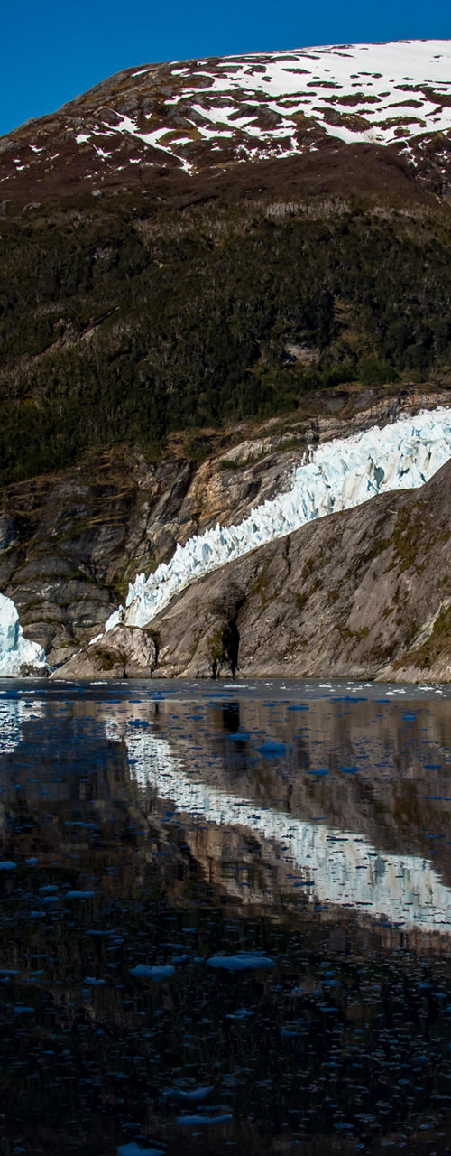 Snowy glacier with mountain reflection