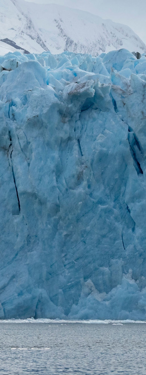 Majestic glacier with snowy mountain backdrop