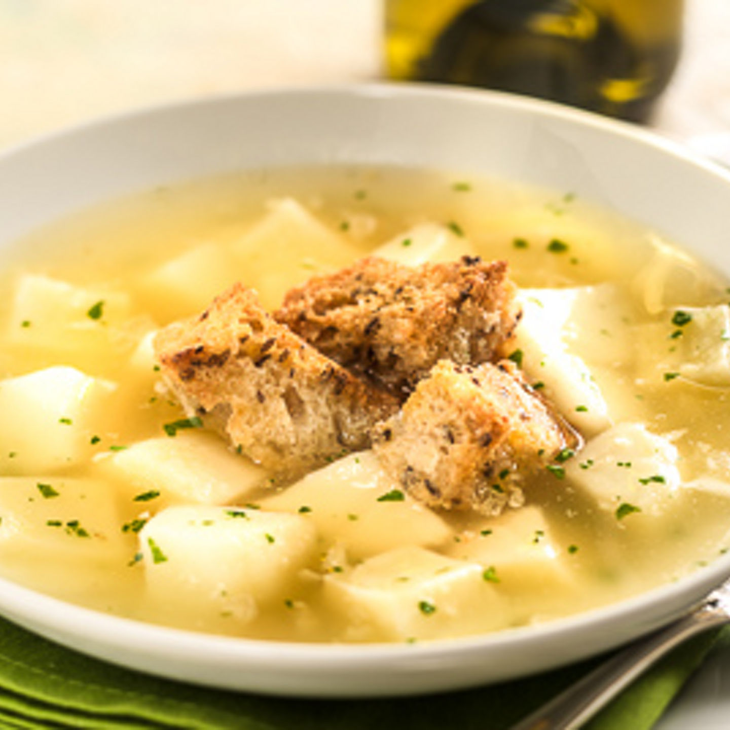 Potato soup with croutons and wine glass