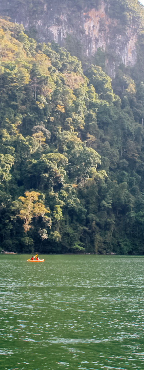 Kayakers in scenic tropical lake setting
