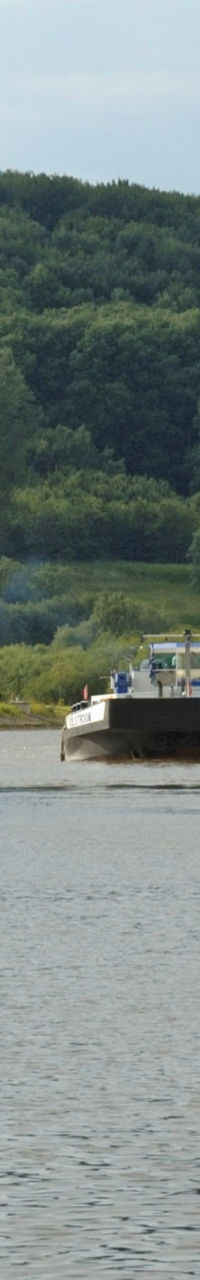 German flag near canal lock and barge