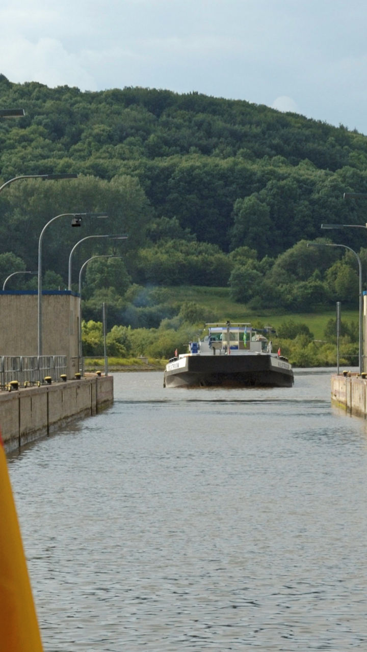 German flag near canal lock and barge