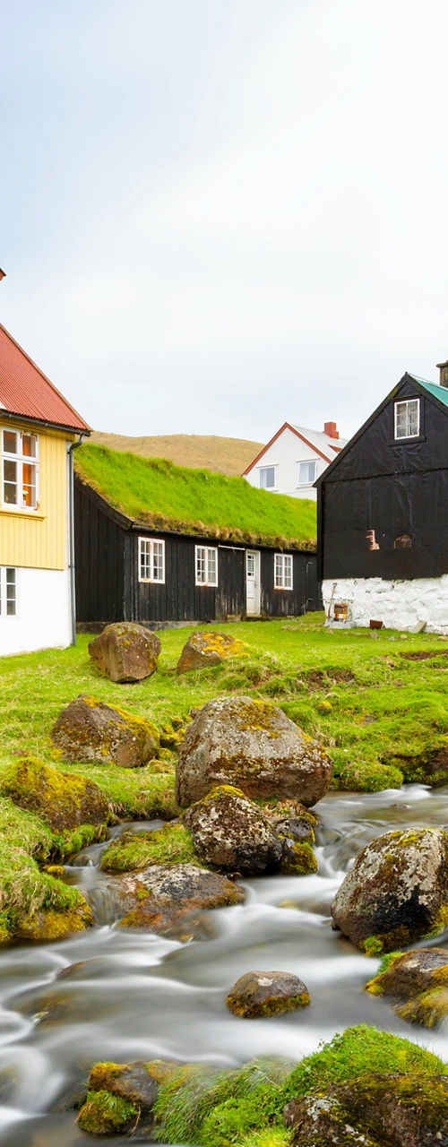 Colorful houses by a flowing stream