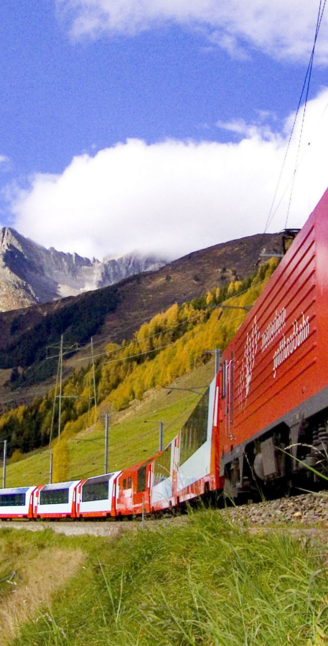 Red train in scenic mountain landscape