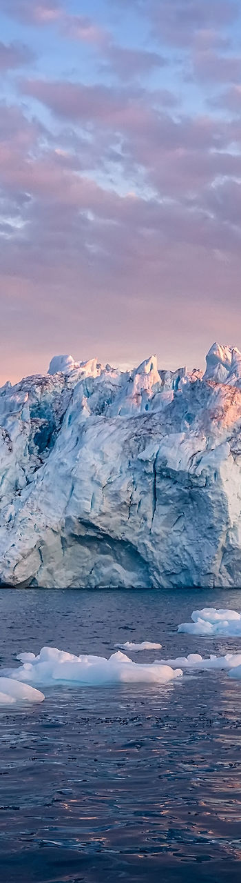 Majestic icebergs at sunset over calm waters