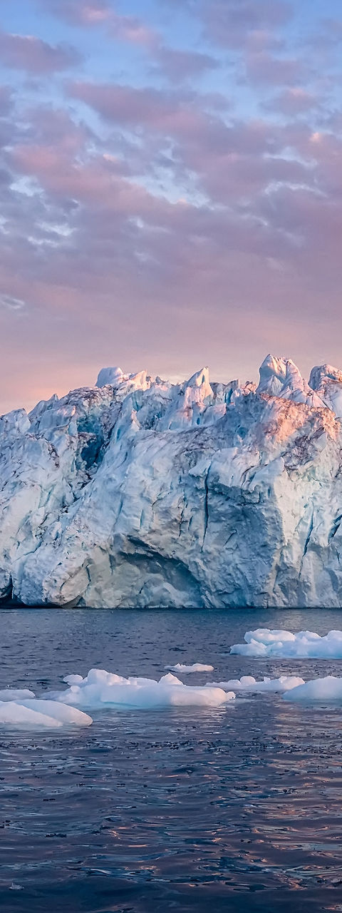 Majestic icebergs at sunset over calm waters