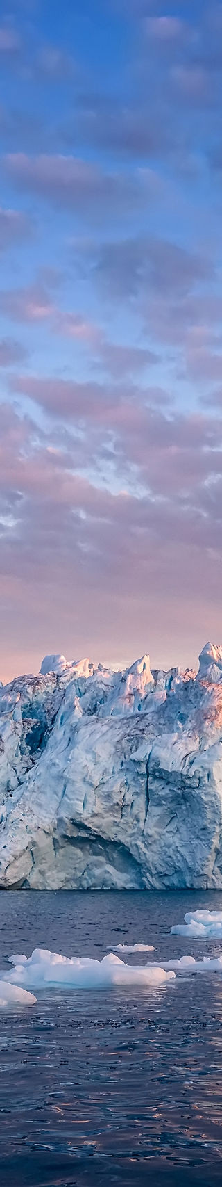 Majestic icebergs at sunset over calm waters