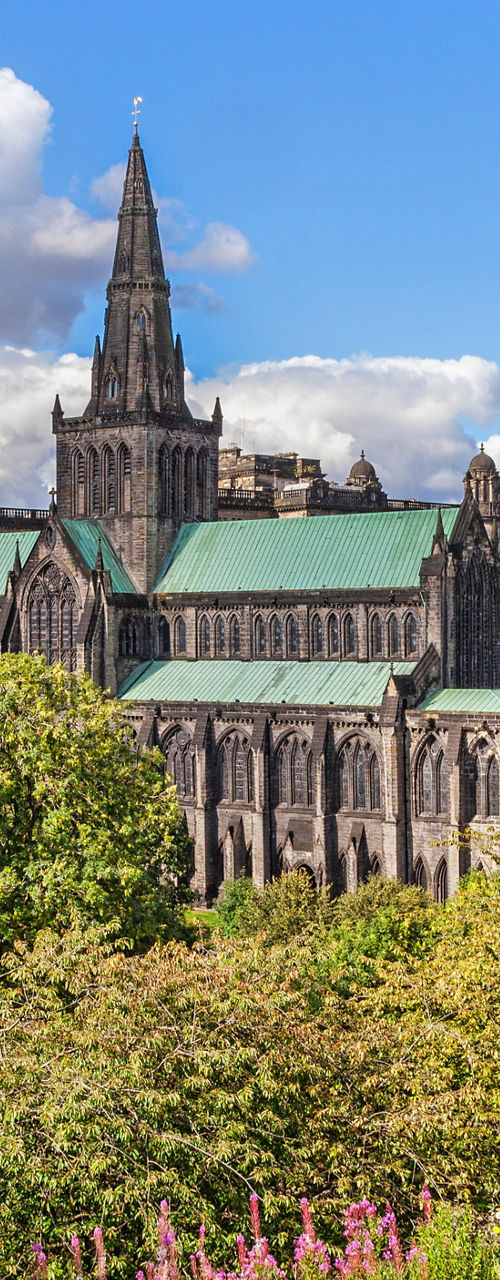 Glasgow Cathedral with lush greenery and blue sky