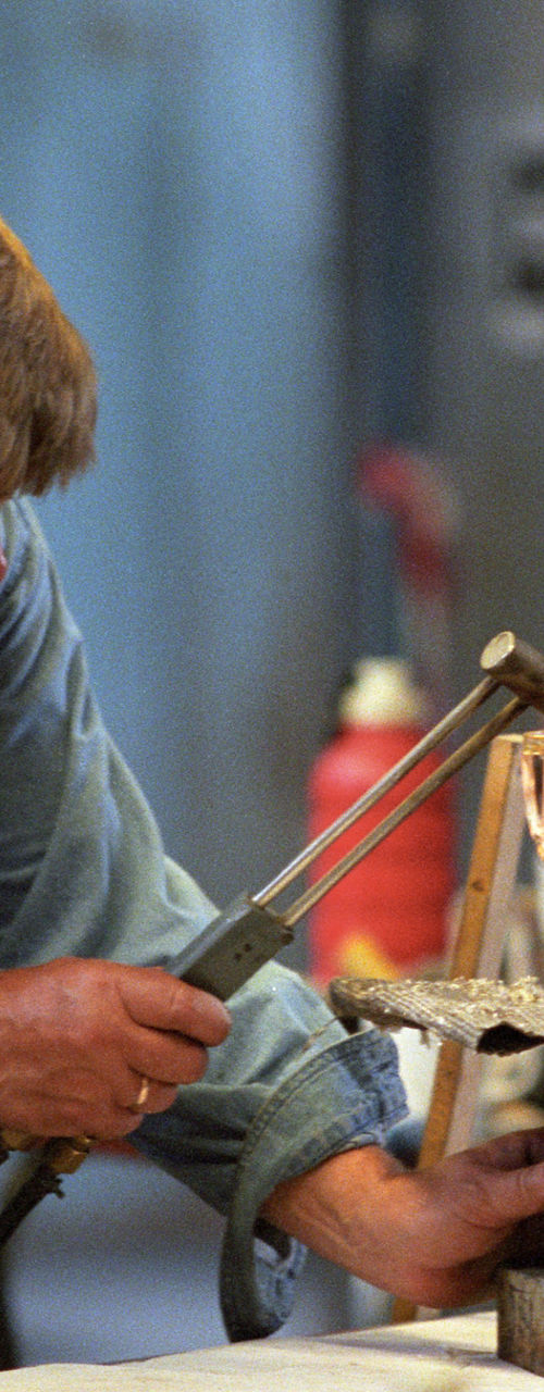 Glassblower crafting intricate glassware