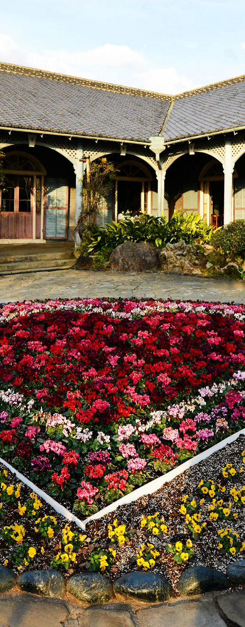 Historic building with vibrant flower garden