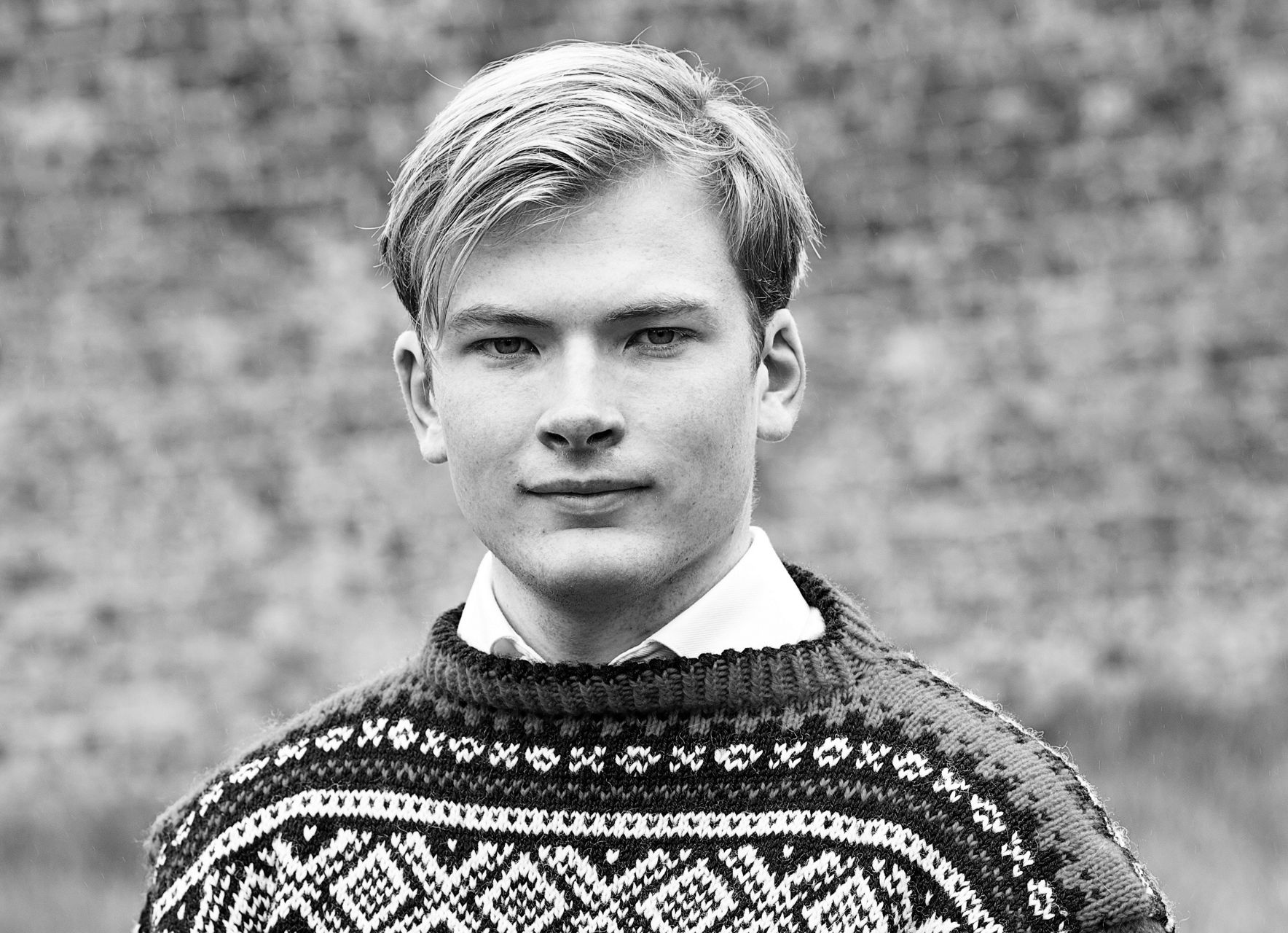 Man in patterned sweater outdoors