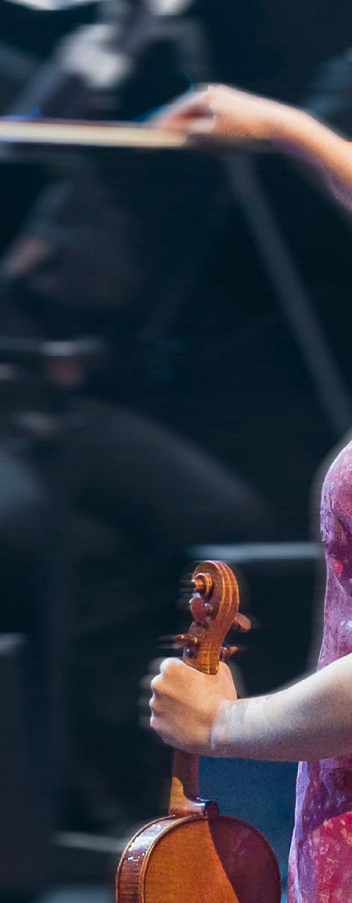 Violinist in red dress performing on stage