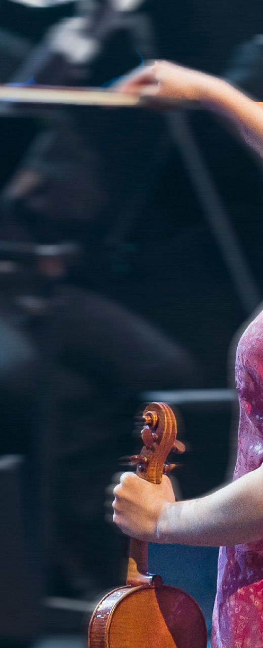 Violinist in red dress performing on stage