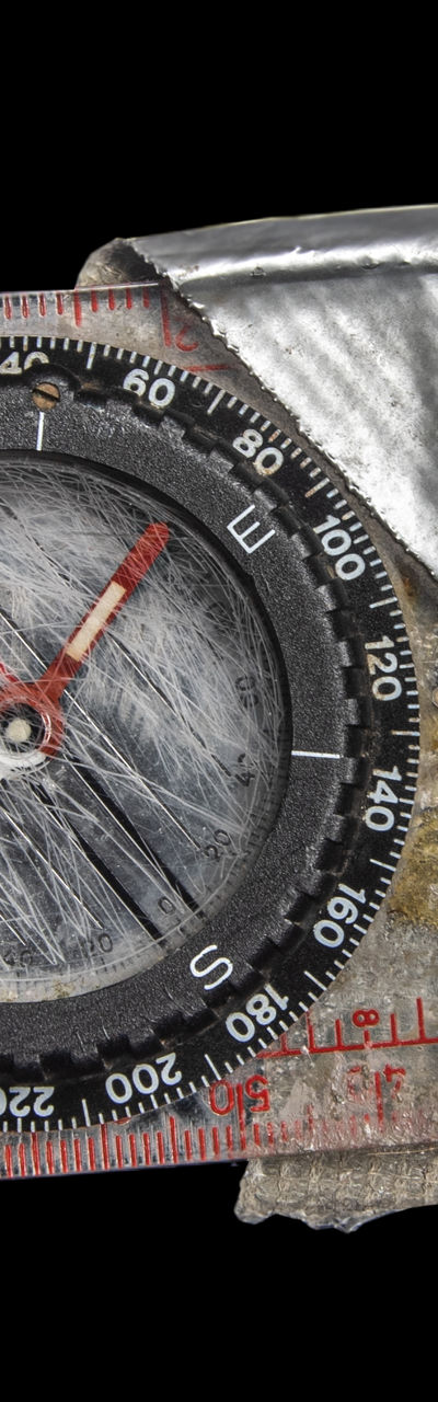 Worn compass with metallic wrapping