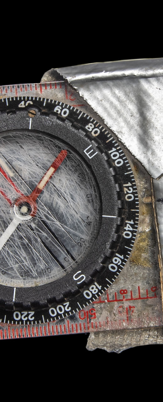Worn compass with metallic wrapping