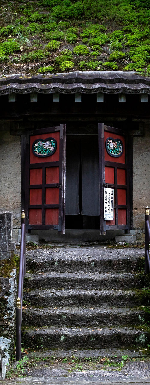 Ancient stone shrine in lush forest setting