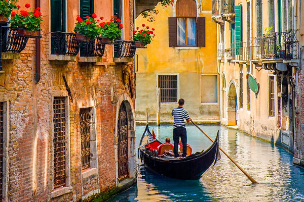 Gondola ride through Venice canal scenery