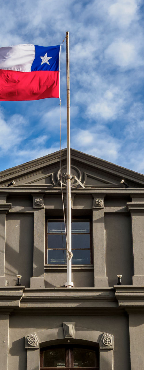Historic building with Chilean flag and blue sky