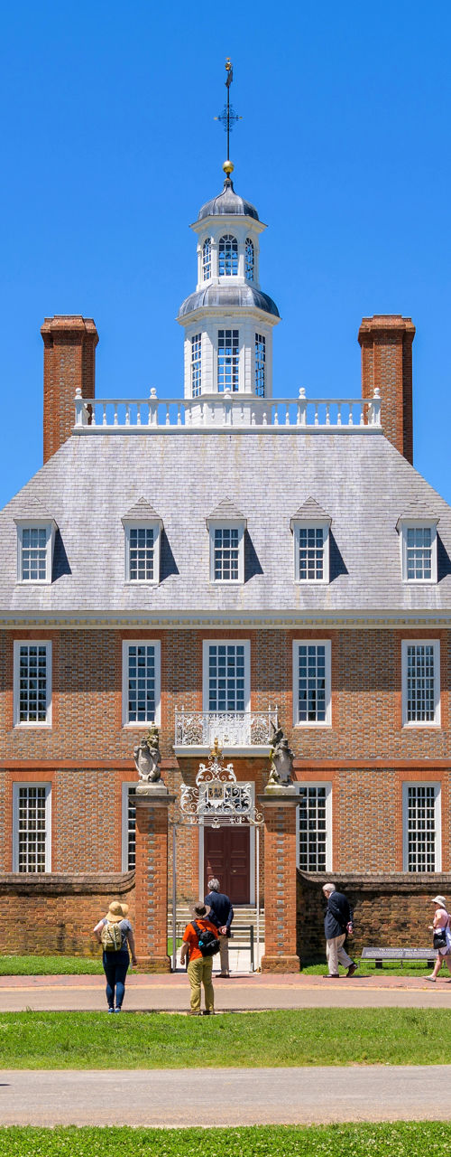 Historic colonial building with visitors outdoors