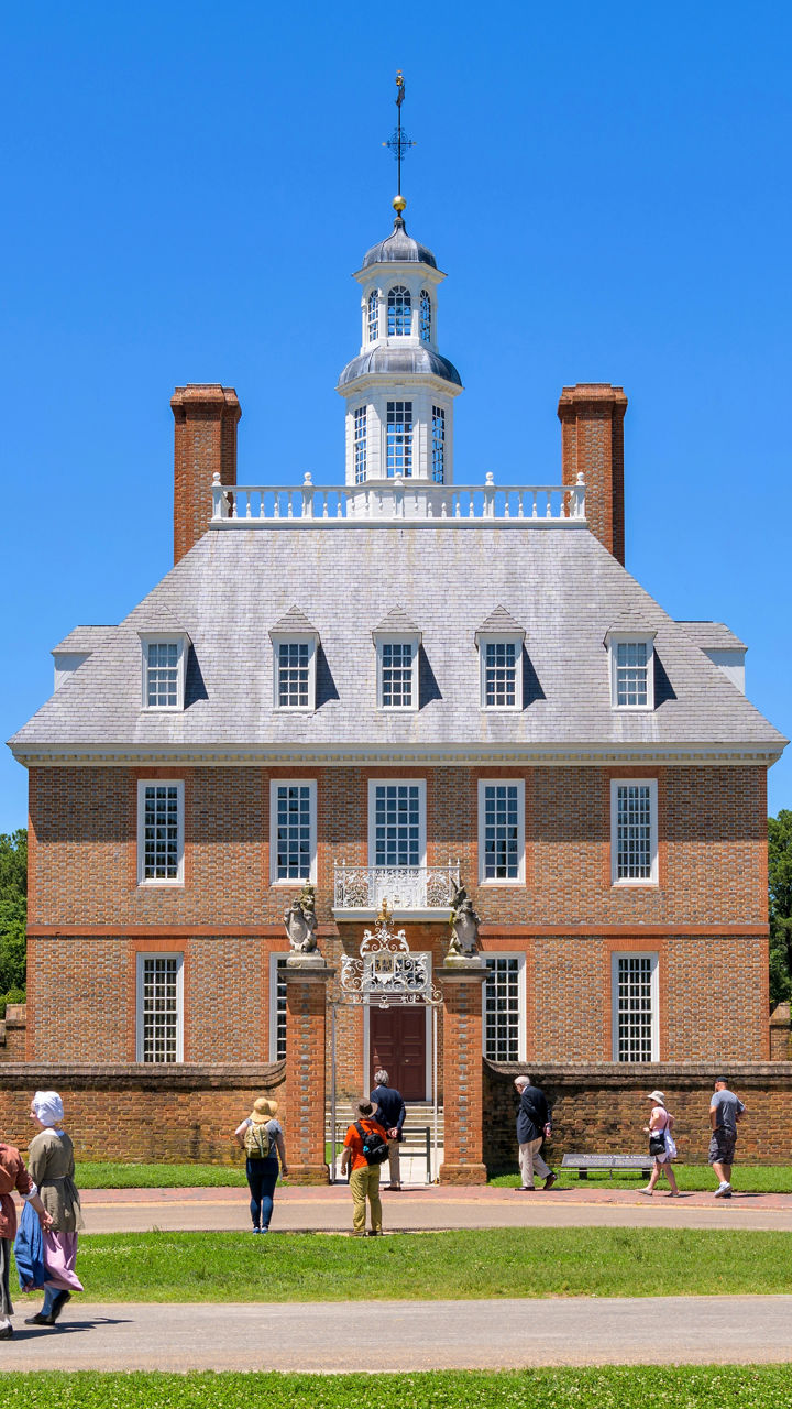 Historic colonial building with visitors outdoors