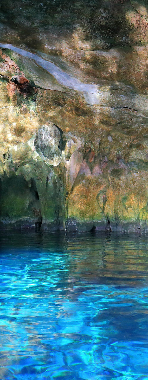 Sunlit Blue Water in Limestone Cave Pool