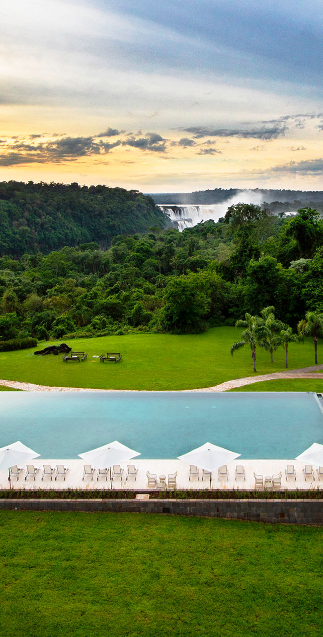 Luxury resort pool overlooking lush landscape