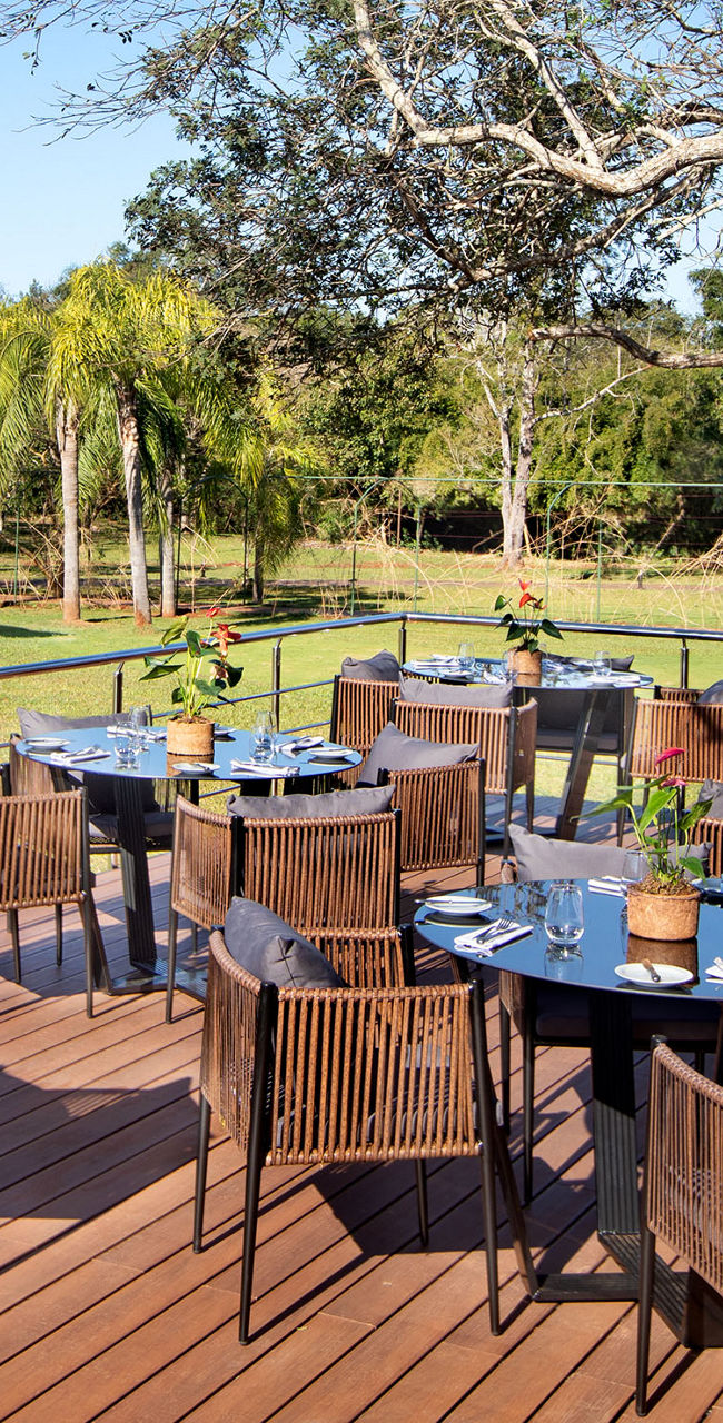 Outdoor dining area with poolside view