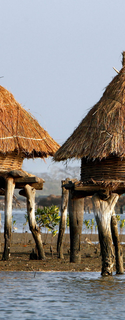 Traditional huts on stilts by the water