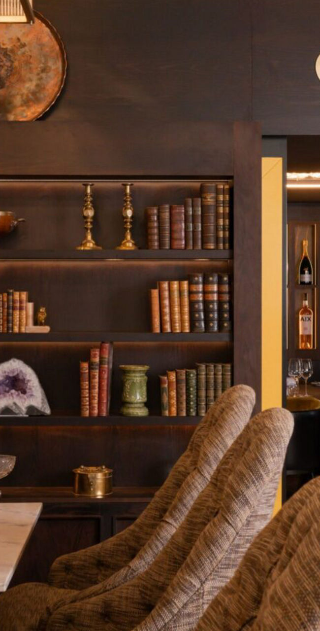 Elegant Lounge with Bookshelf and Wine Room Entrance