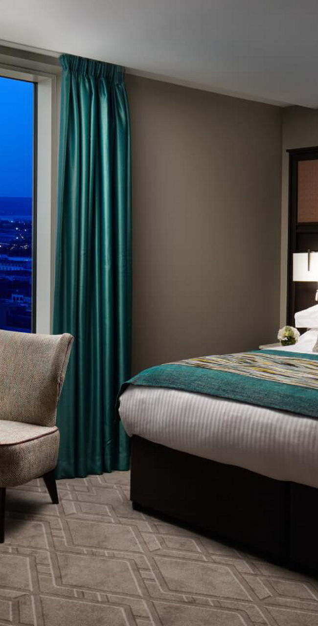 Modern Hotel Room with City View at Dusk