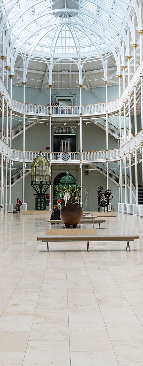 Spacious museum hall with sculptures and exhibits