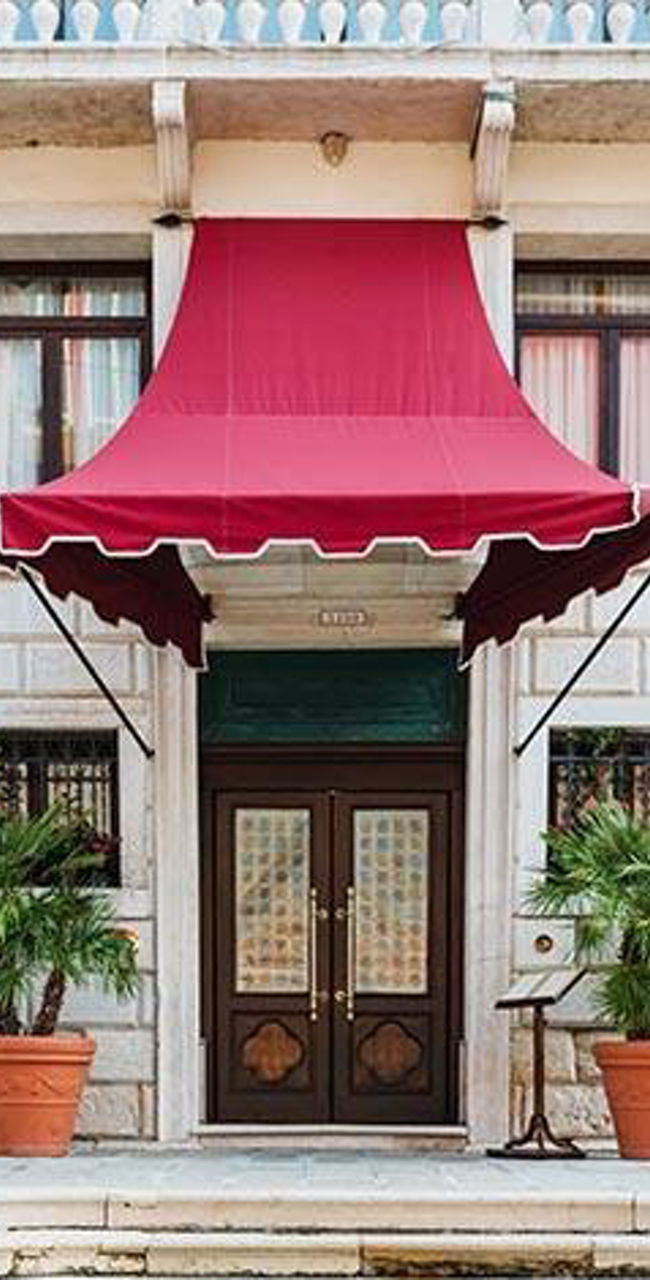 Venetian building with red striped poles