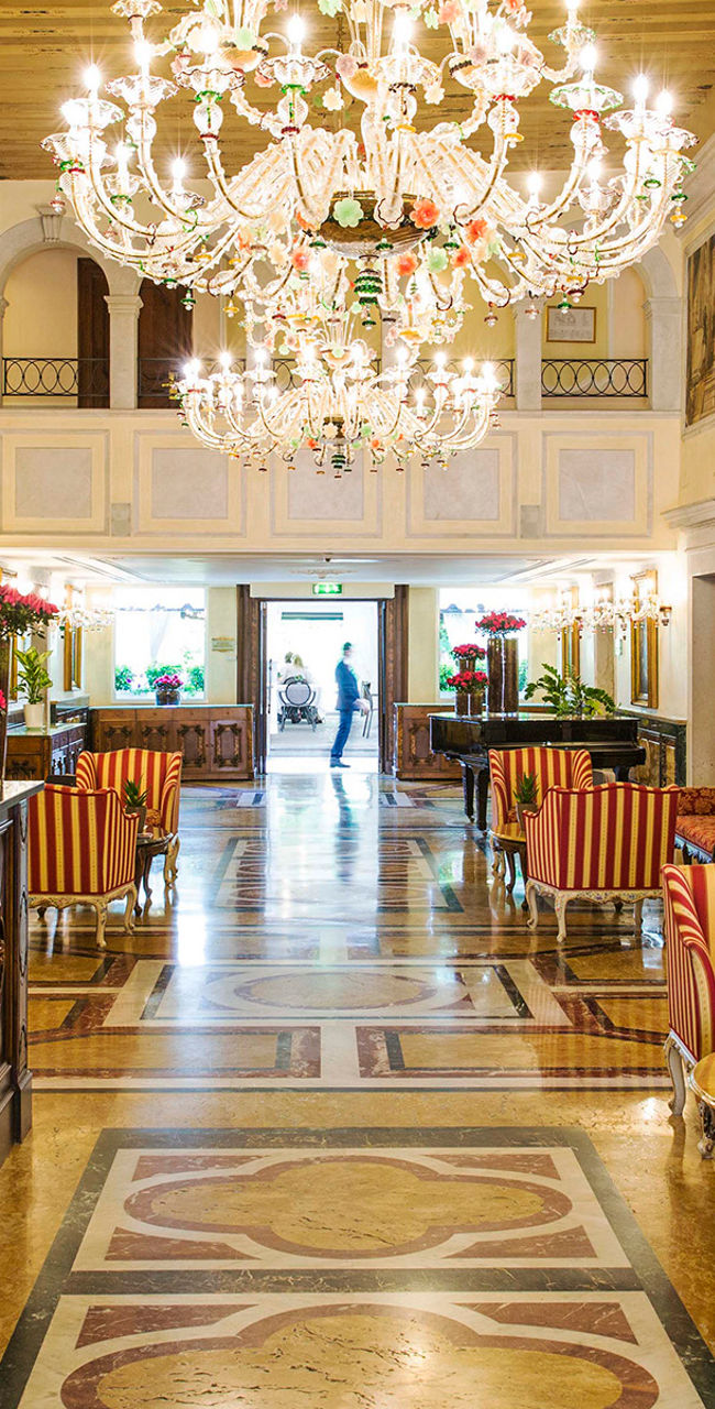 Elegant hotel lobby with chandeliers and decor