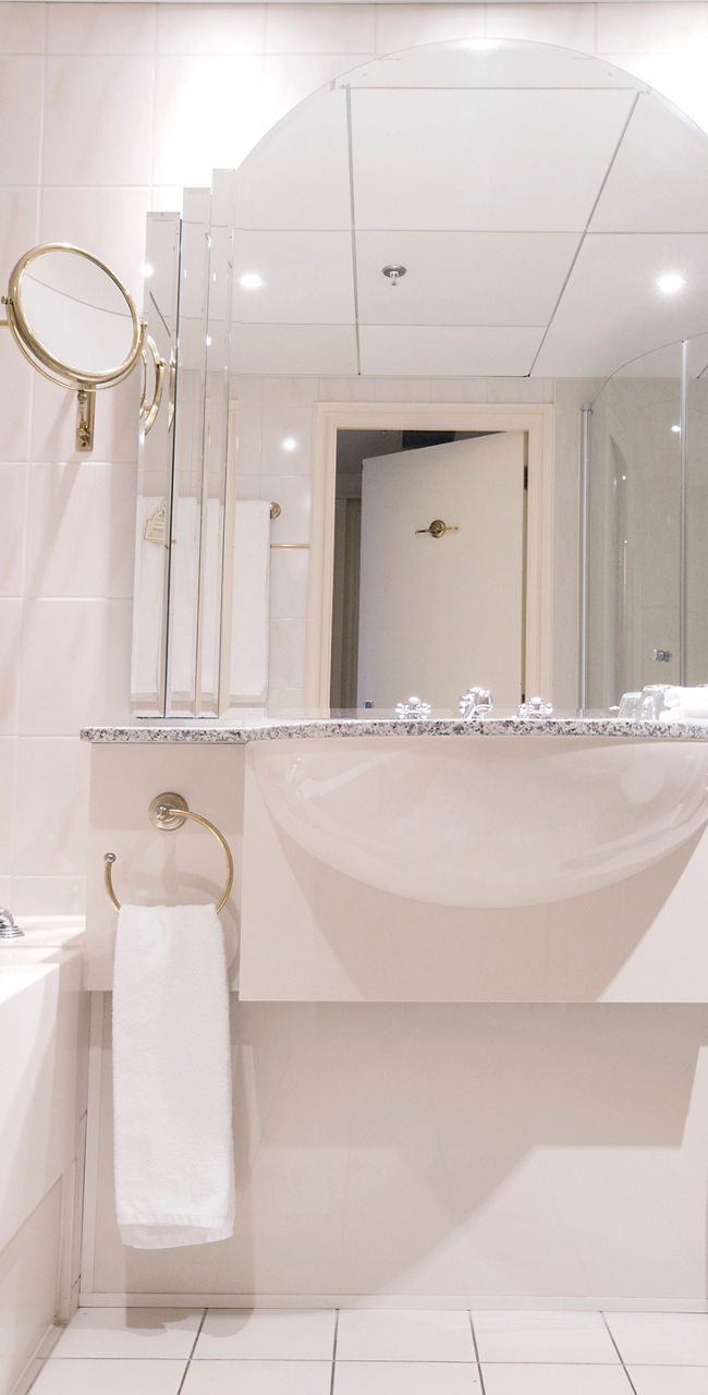 Modern hotel bathroom with white decor