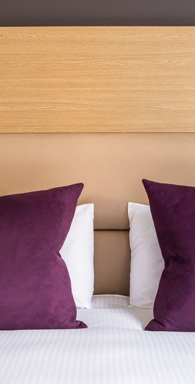 Modern hotel room with purple accents