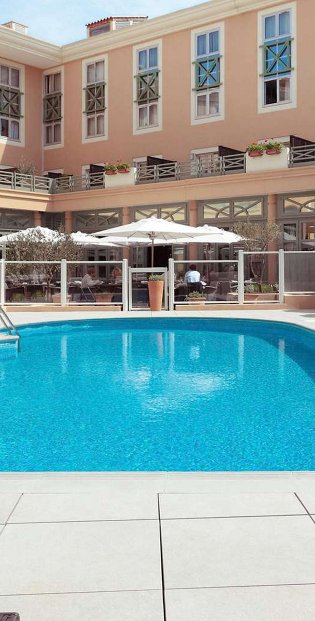 Luxury hotel pool with lounge chairs