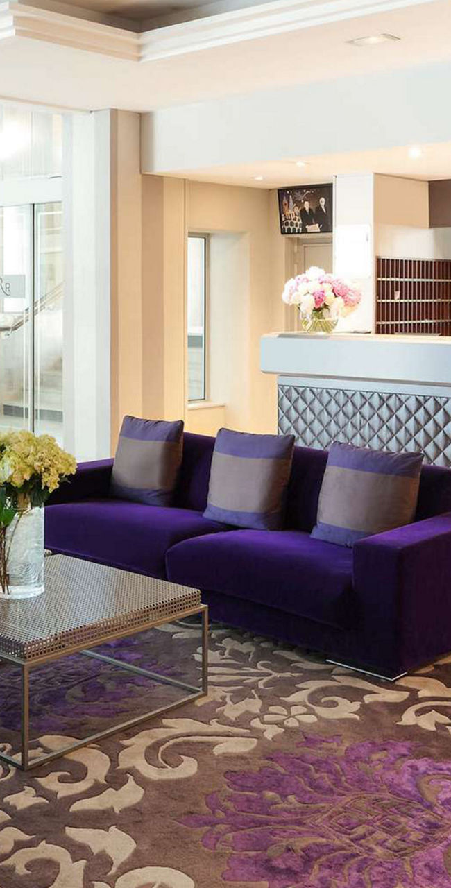 Modern hotel lobby with purple seating