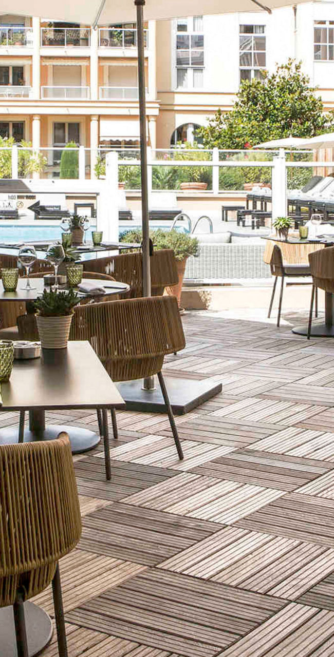 Outdoor dining area with poolside view